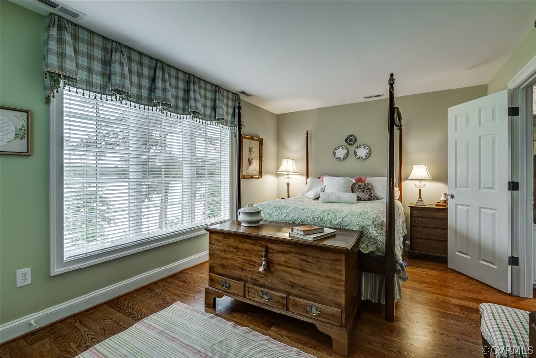 1571 Pine Hall Road Mathews, VA 23109 - Photo 31 of 48 a bedroom with a bed and wooden floor