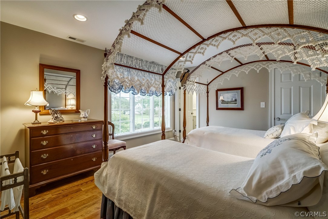 1571 Pine Hall Road Mathews, VA 23109 - Photo 32 of 48 a bedroom with a bed and wooden floor