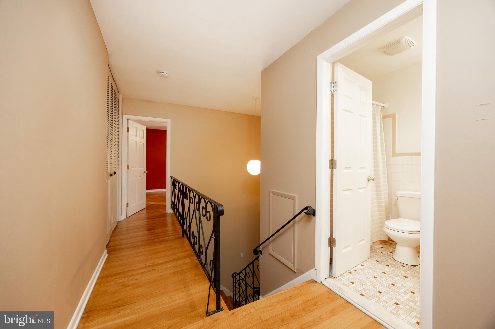208 Morris Road Exton, PA 19341 - Photo 14 of 43 a view of a hallway with wooden floor and staircase