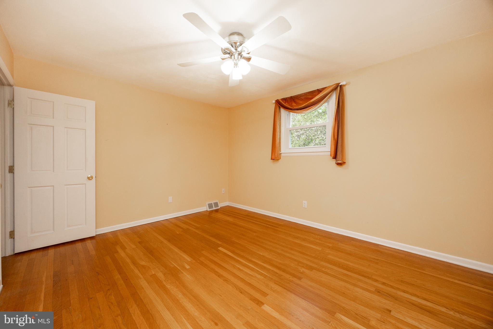 208 Morris Road Exton, PA 19341 - Photo 23 of 43 an empty room with a window and wooden floor
