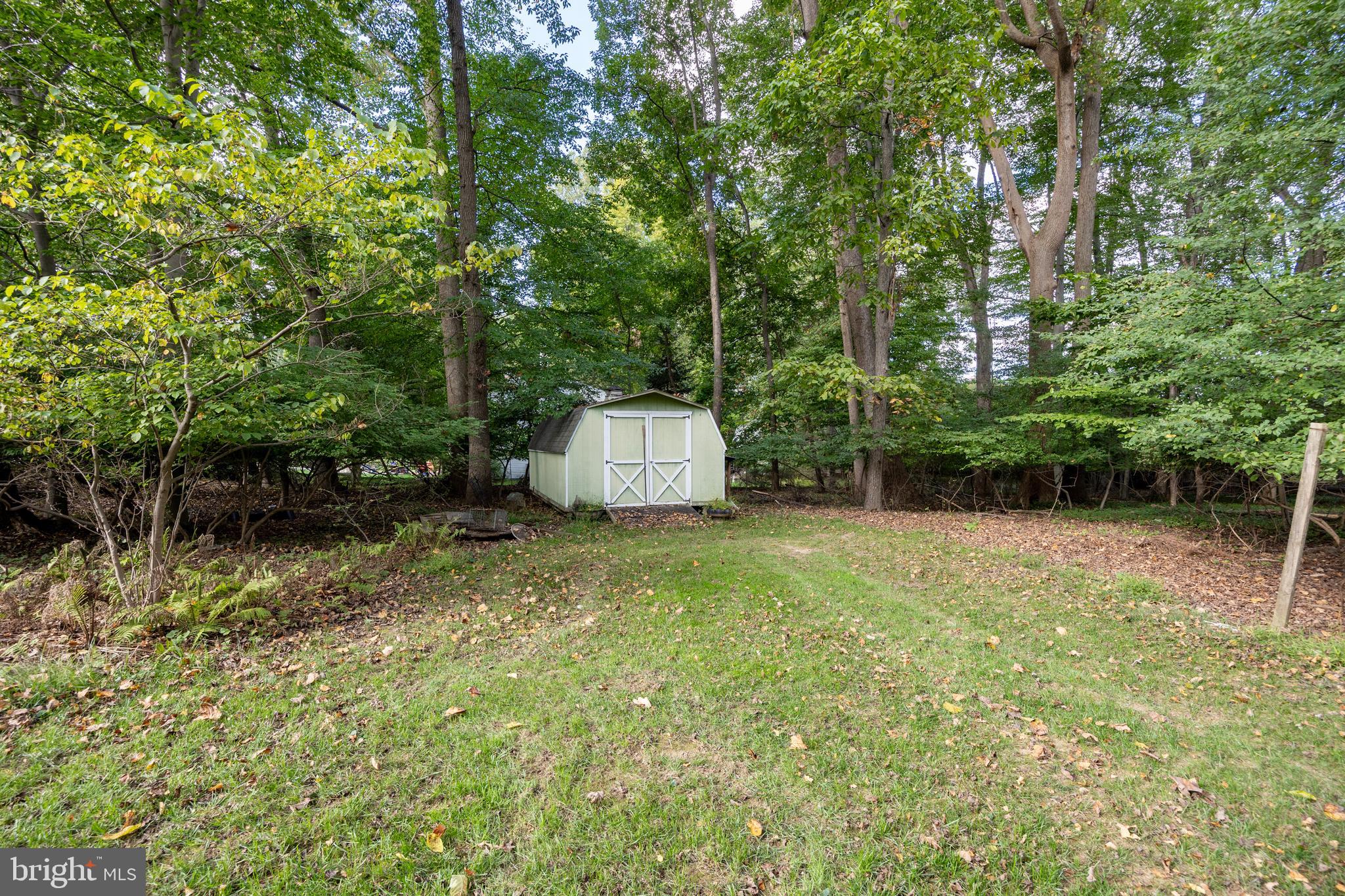208 Morris Road Exton, PA 19341 - Photo 31 of 43 a backyard of a house with large trees and plants