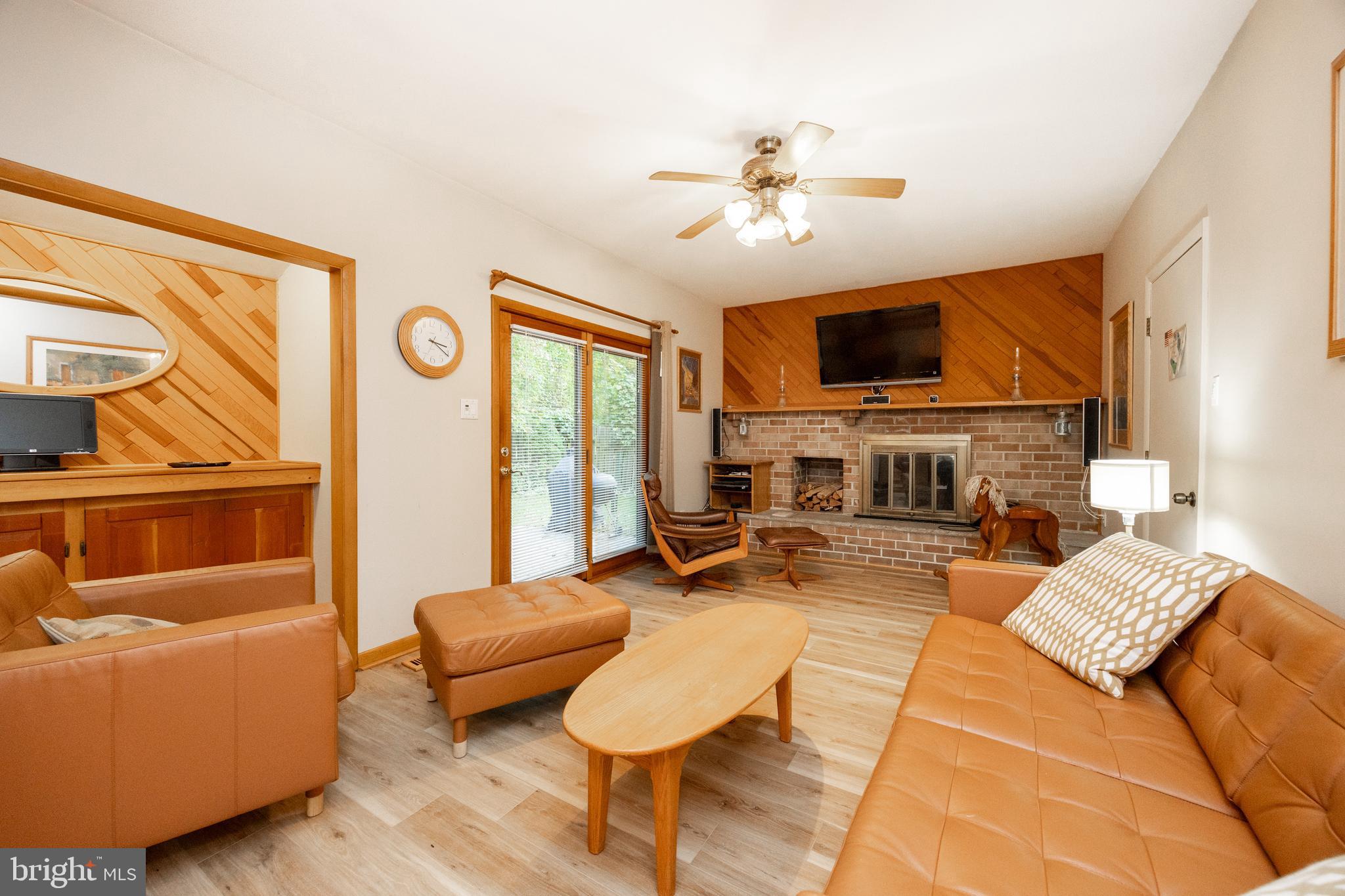 208 Morris Road Exton, PA 19341 - Photo 5 of 43 a living room with furniture a flat screen tv and a large window