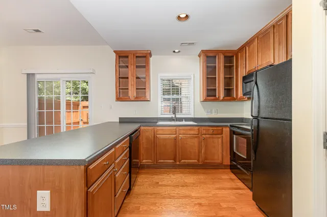 a kitchen with stainless steel appliances granite countertop a refrigerator sink and cabinets