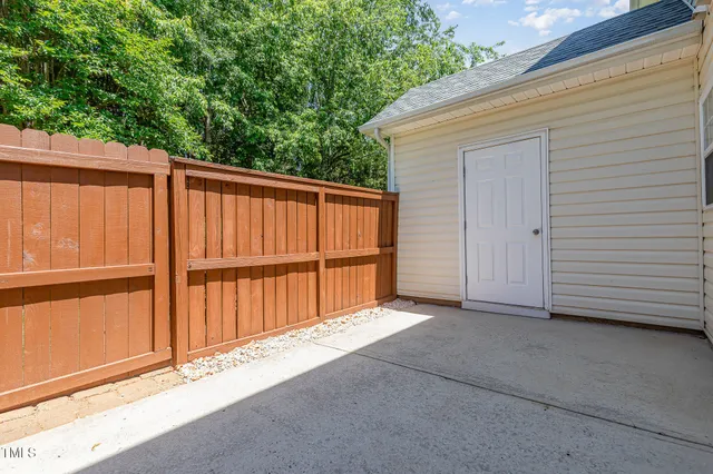 a view of backyard with tub and trees in the background