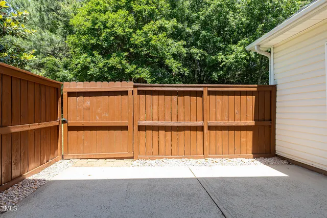 a view of a wooden fence with a big yard