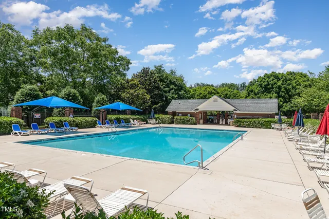an outdoor space with pool and furniture