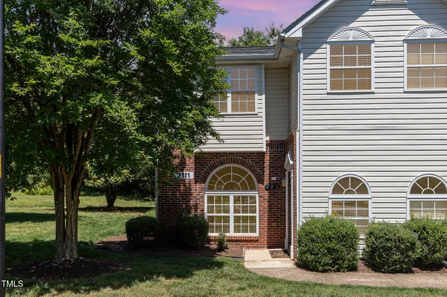 a front view of a building with parking space