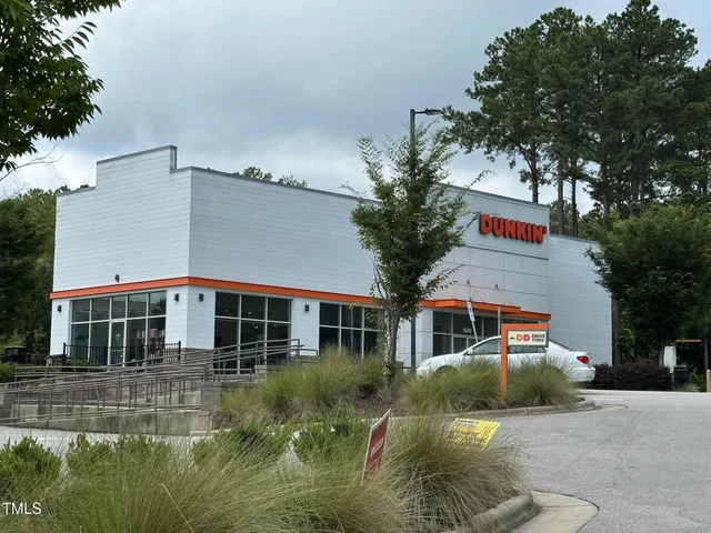 a view of a brick house with large windows