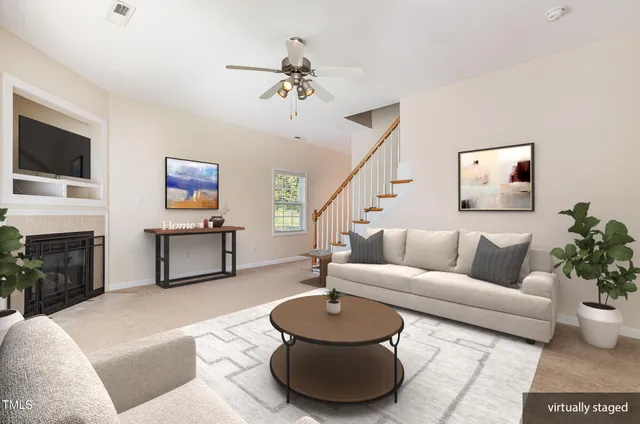 a living room with furniture a fireplace and a flat screen tv