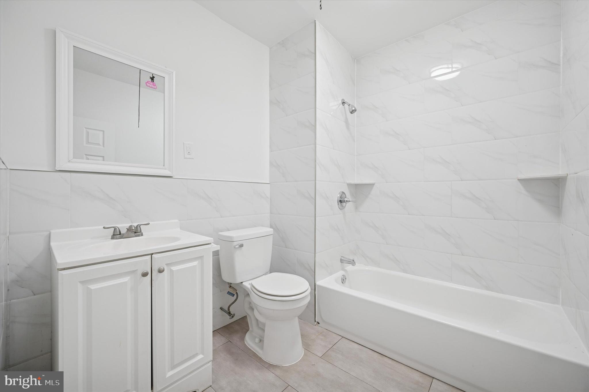 892 Granite Street Philadelphia, PA 19124 - Photo 13 of 15 a bathroom with a sink a toilet and a bathtub