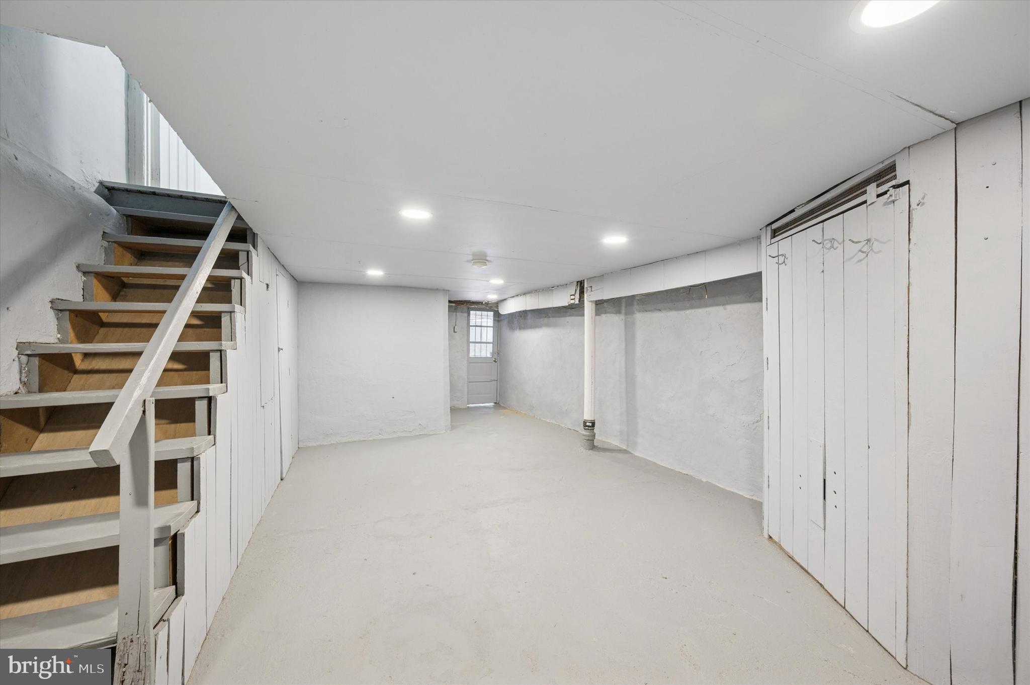 892 Granite Street Philadelphia, PA 19124 - Photo 14 of 15 a view of an empty room with wooden floor and stairs