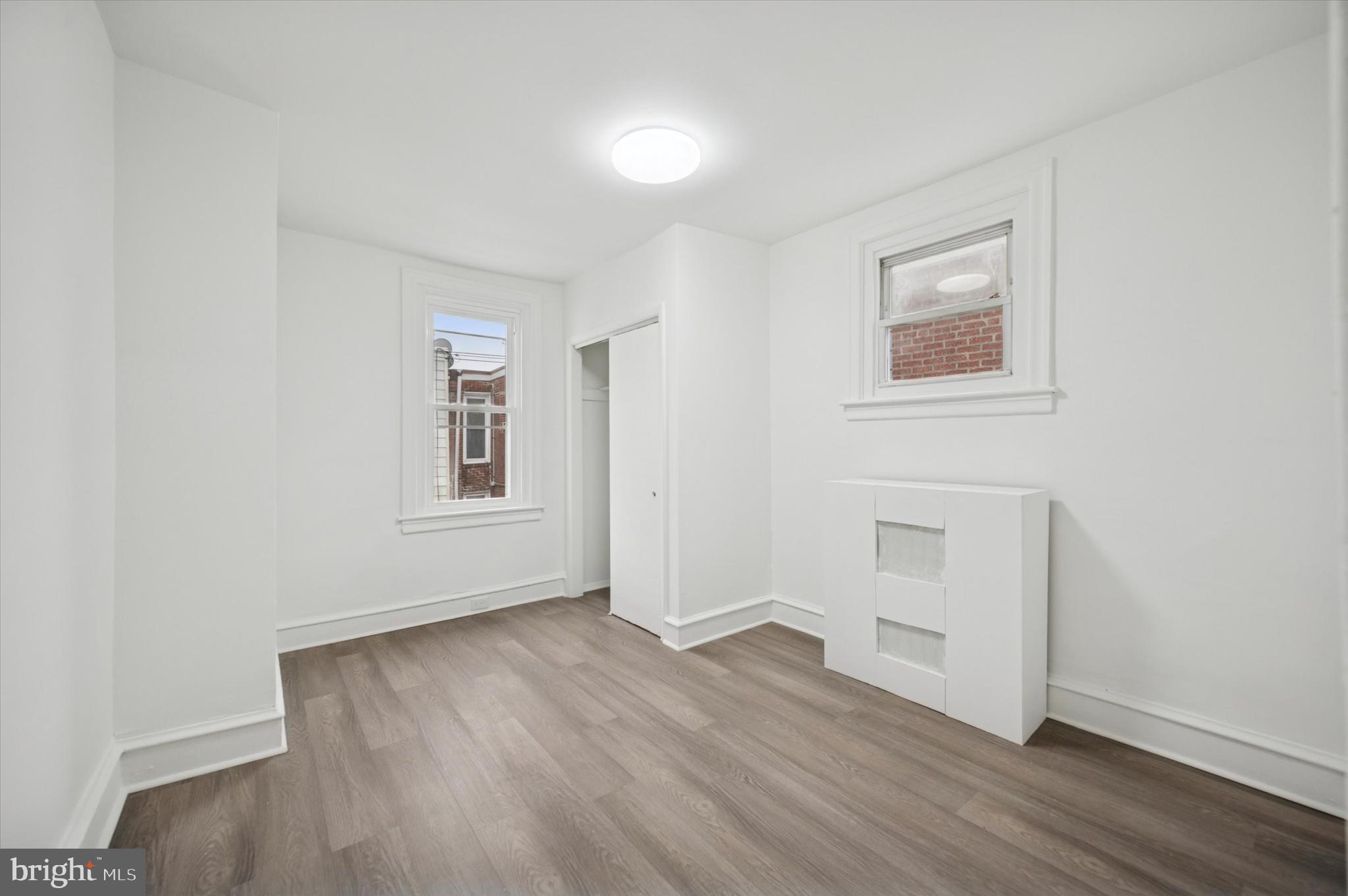 892 Granite Street Philadelphia, PA 19124 - Photo 8 of 15 an empty room with wooden floor and windows