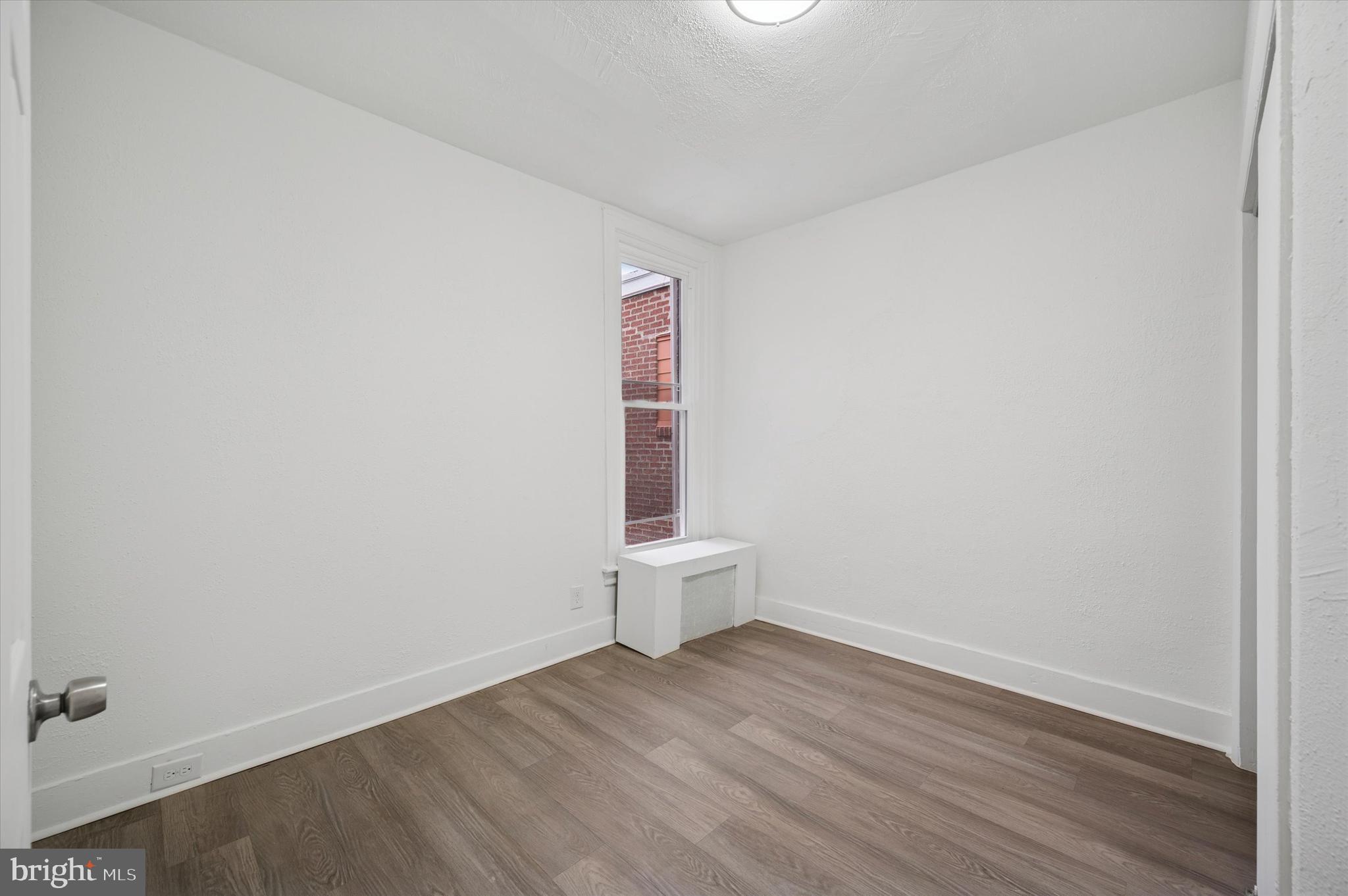 892 Granite Street Philadelphia, PA 19124 - Photo 10 of 15 a view of a small space with wooden floor and a window
