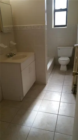a bathroom with a sink toilet and window
