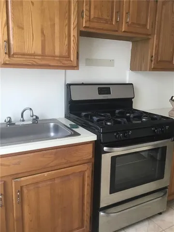 a stove top oven sitting inside of a kitchen
