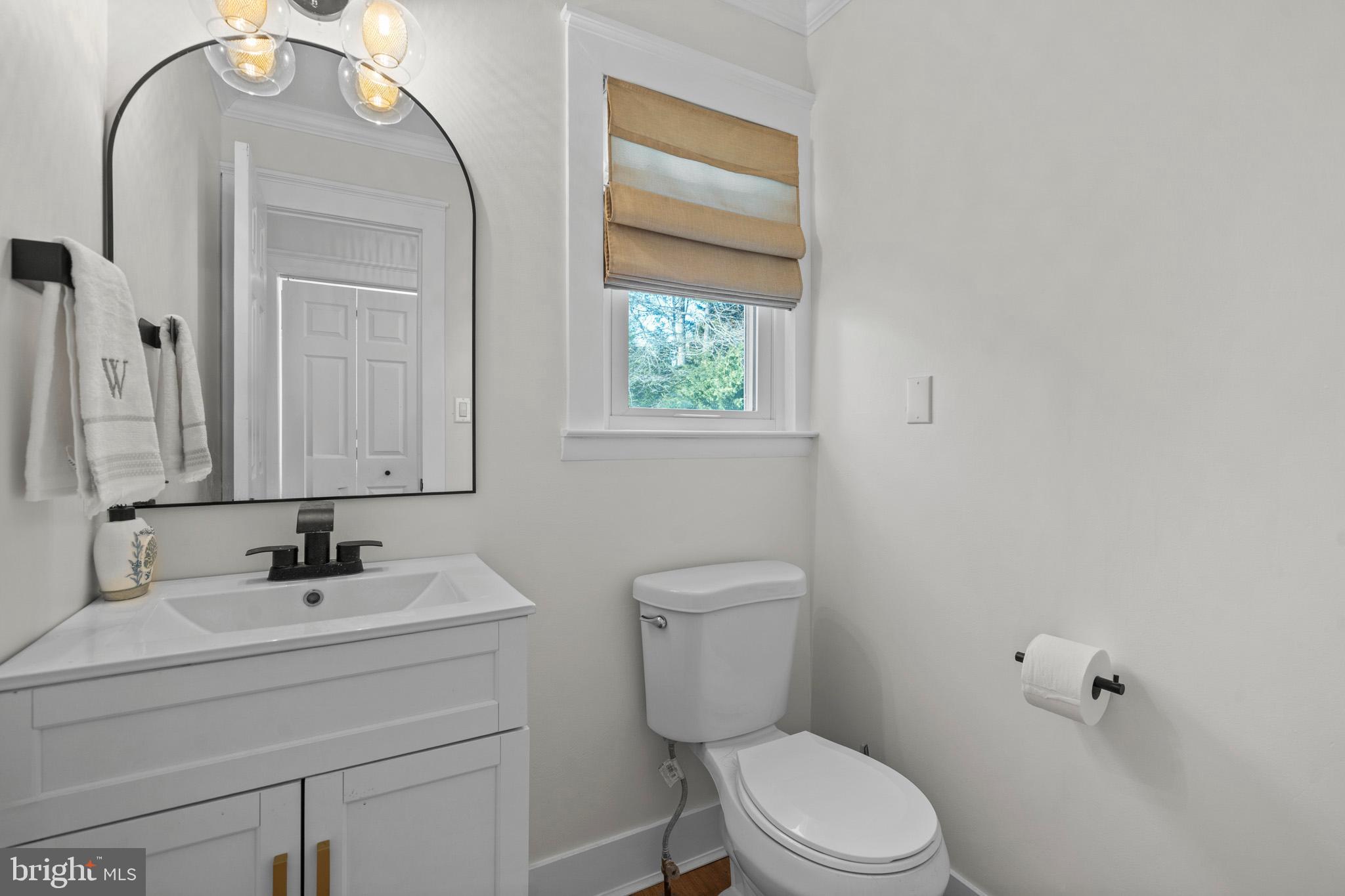 3704 9th Street North Beach, MD 20714 - Photo 16 of 42 a bathroom with a sink a toilet and a mirror