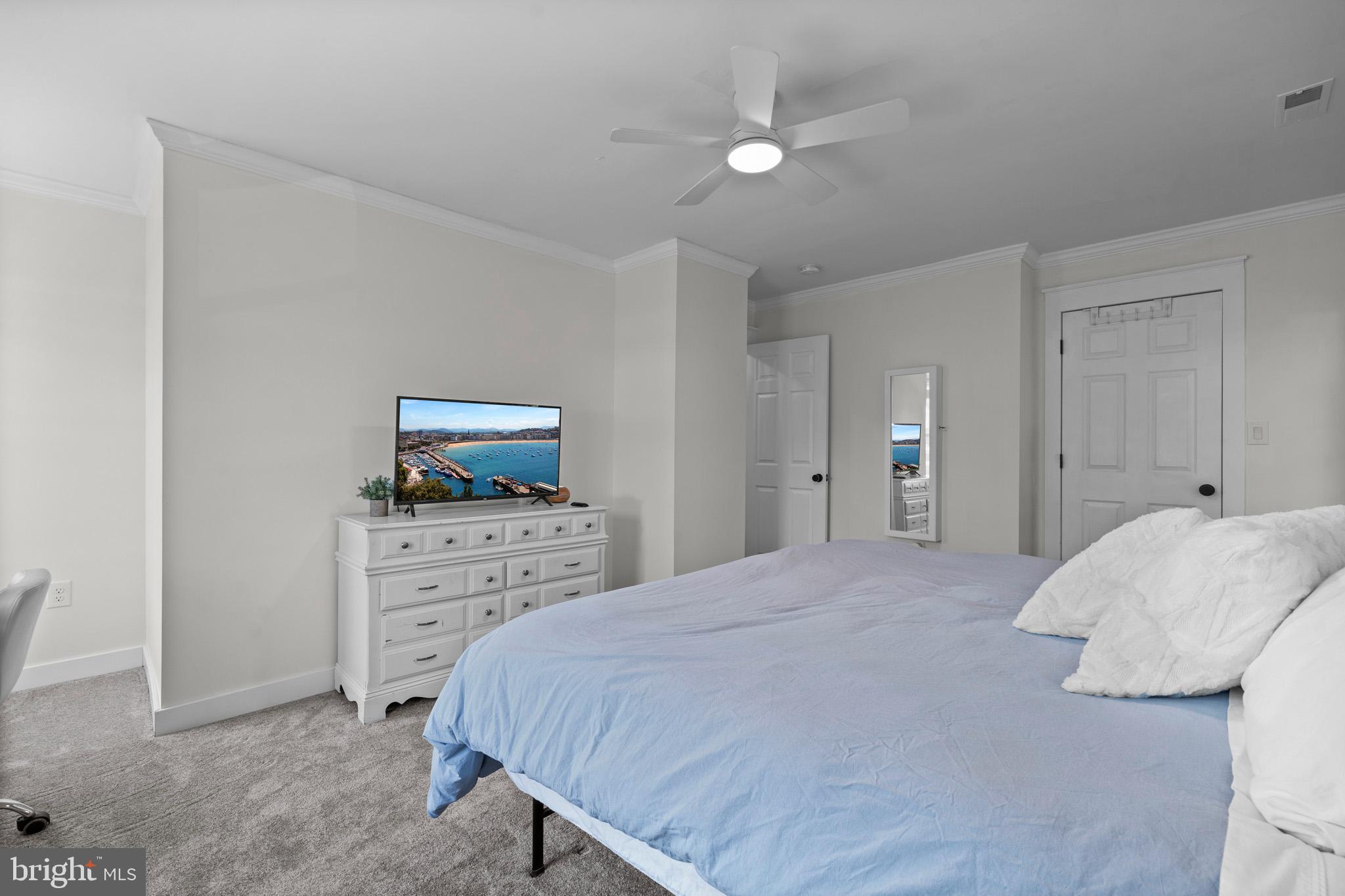 3704 9th Street North Beach, MD 20714 - Photo 17 of 42 a bedroom with a bed and a couch