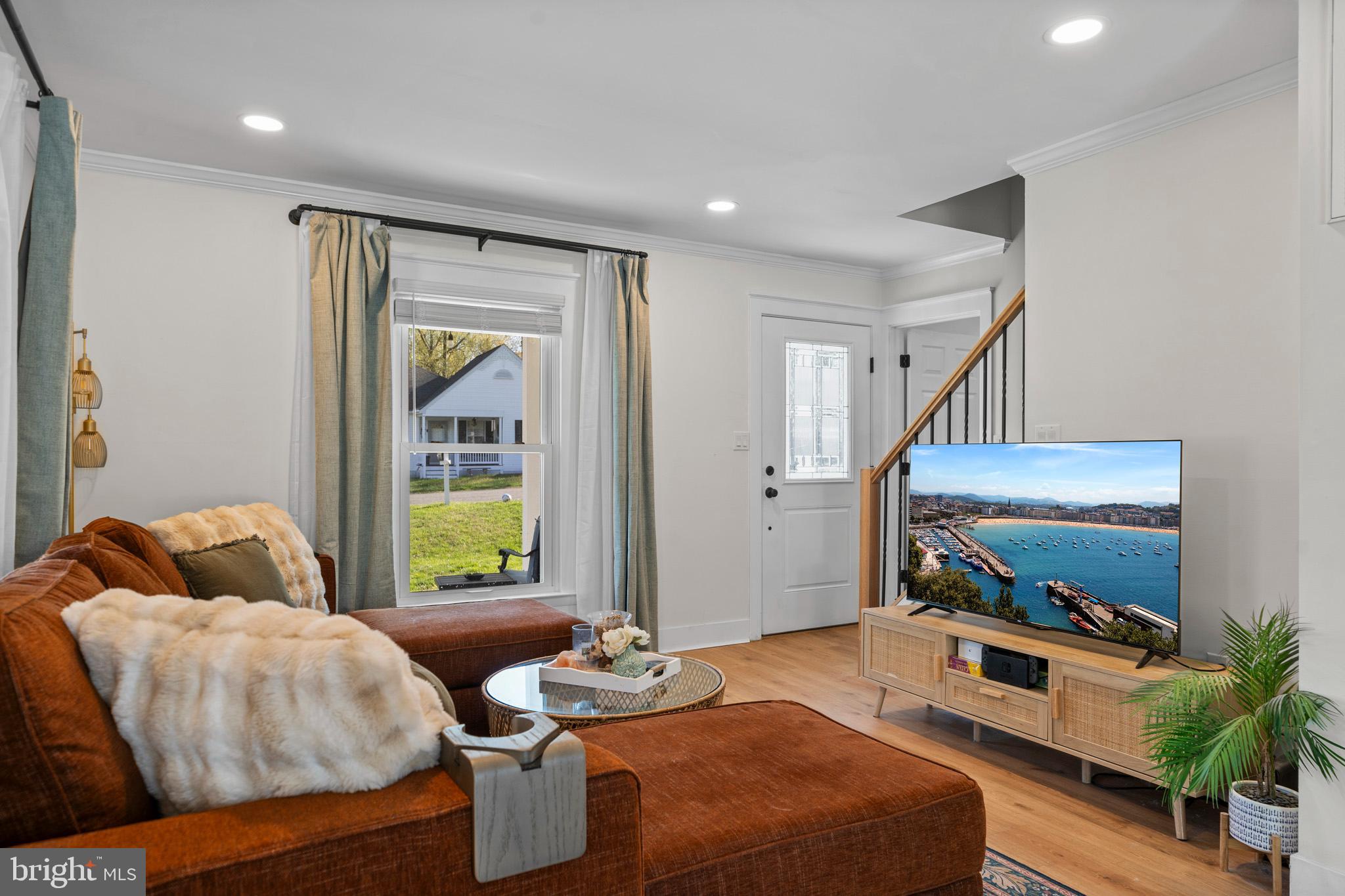 3704 9th Street North Beach, MD 20714 - Photo 2 of 42 a living room with furniture and a flat screen tv