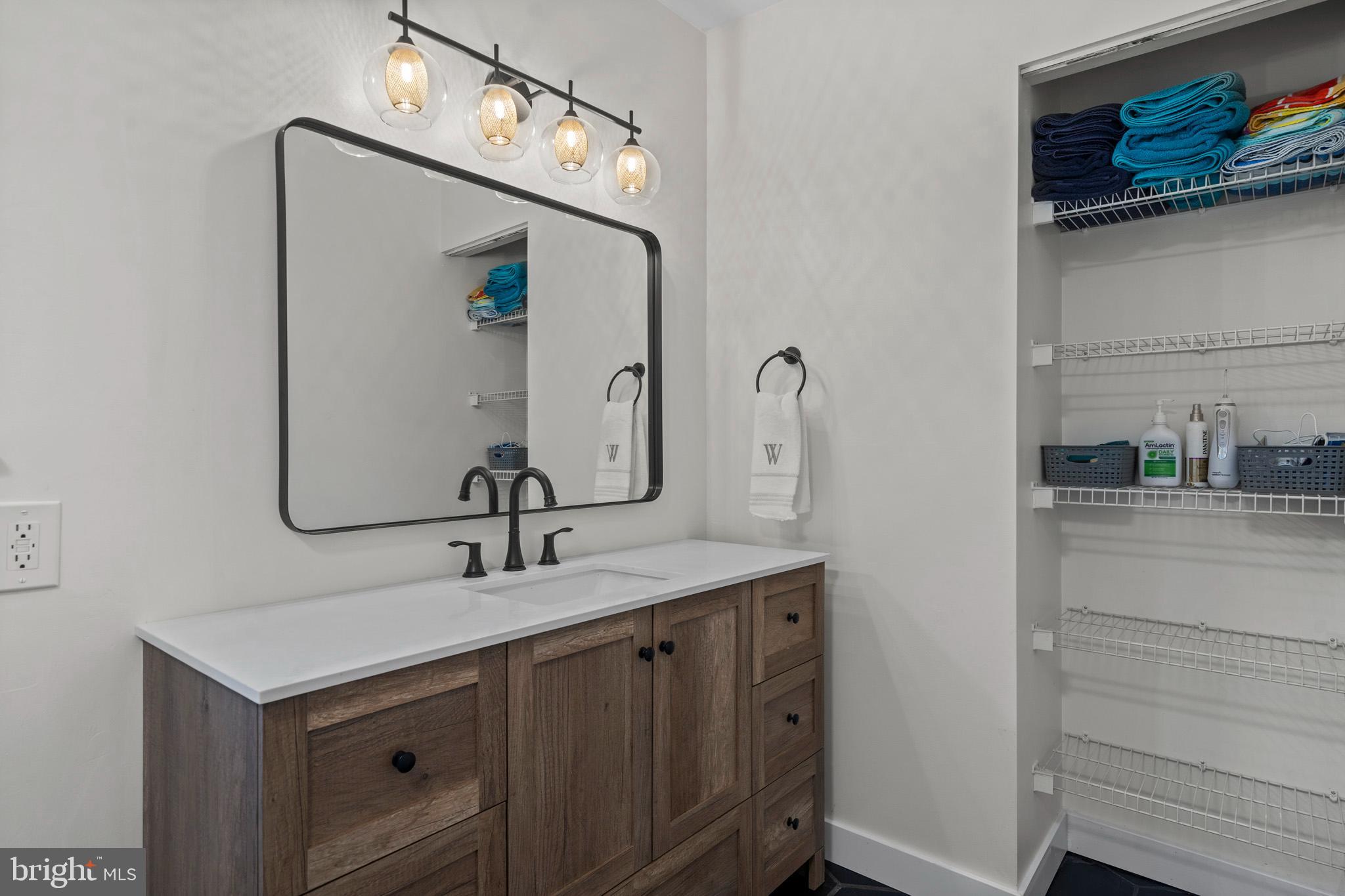 3704 9th Street North Beach, MD 20714 - Photo 20 of 42 a bathroom with a sink and a mirror