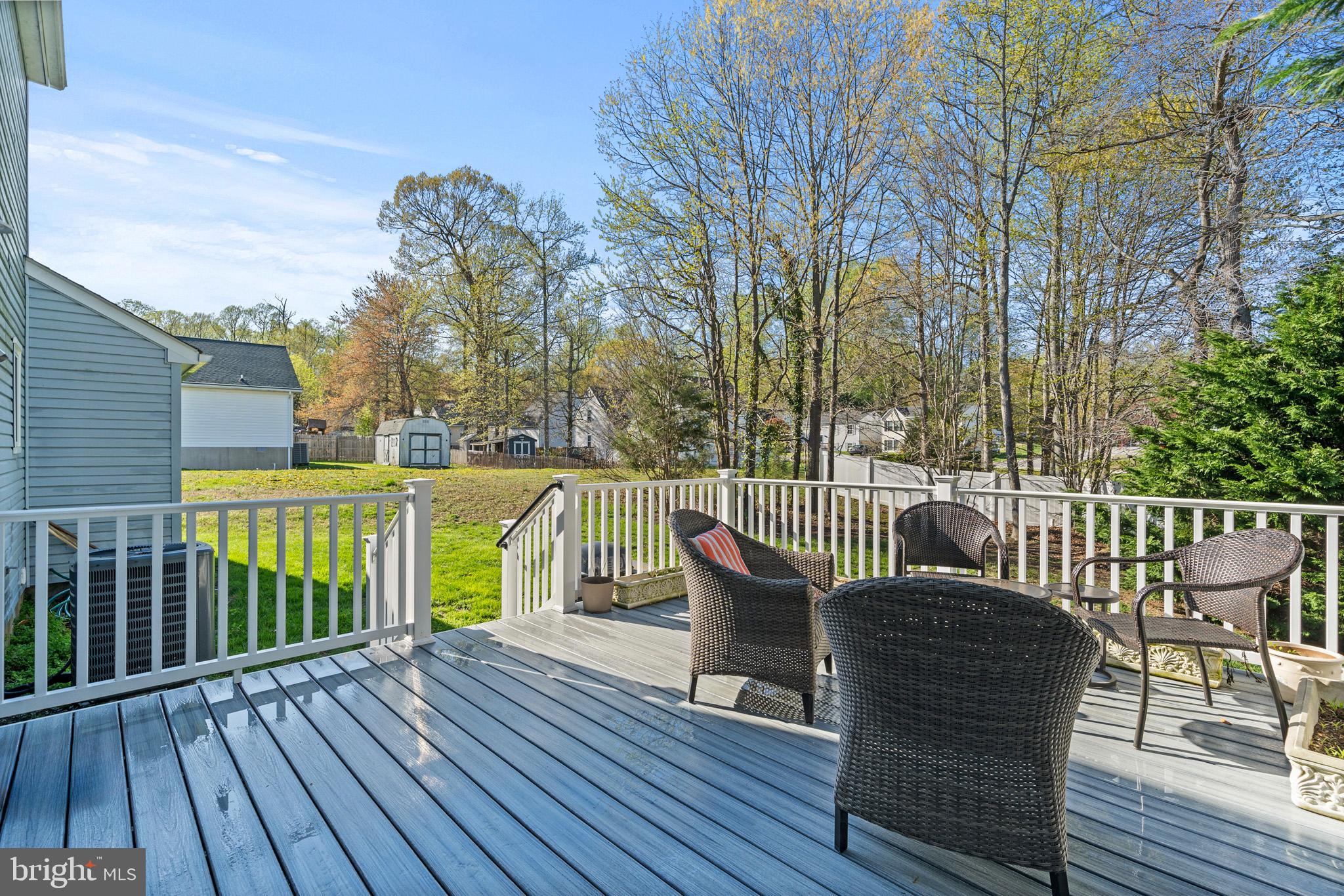 3704 9th Street North Beach, MD 20714 - Photo 23 of 42 a view of a deck with furniture and trees around