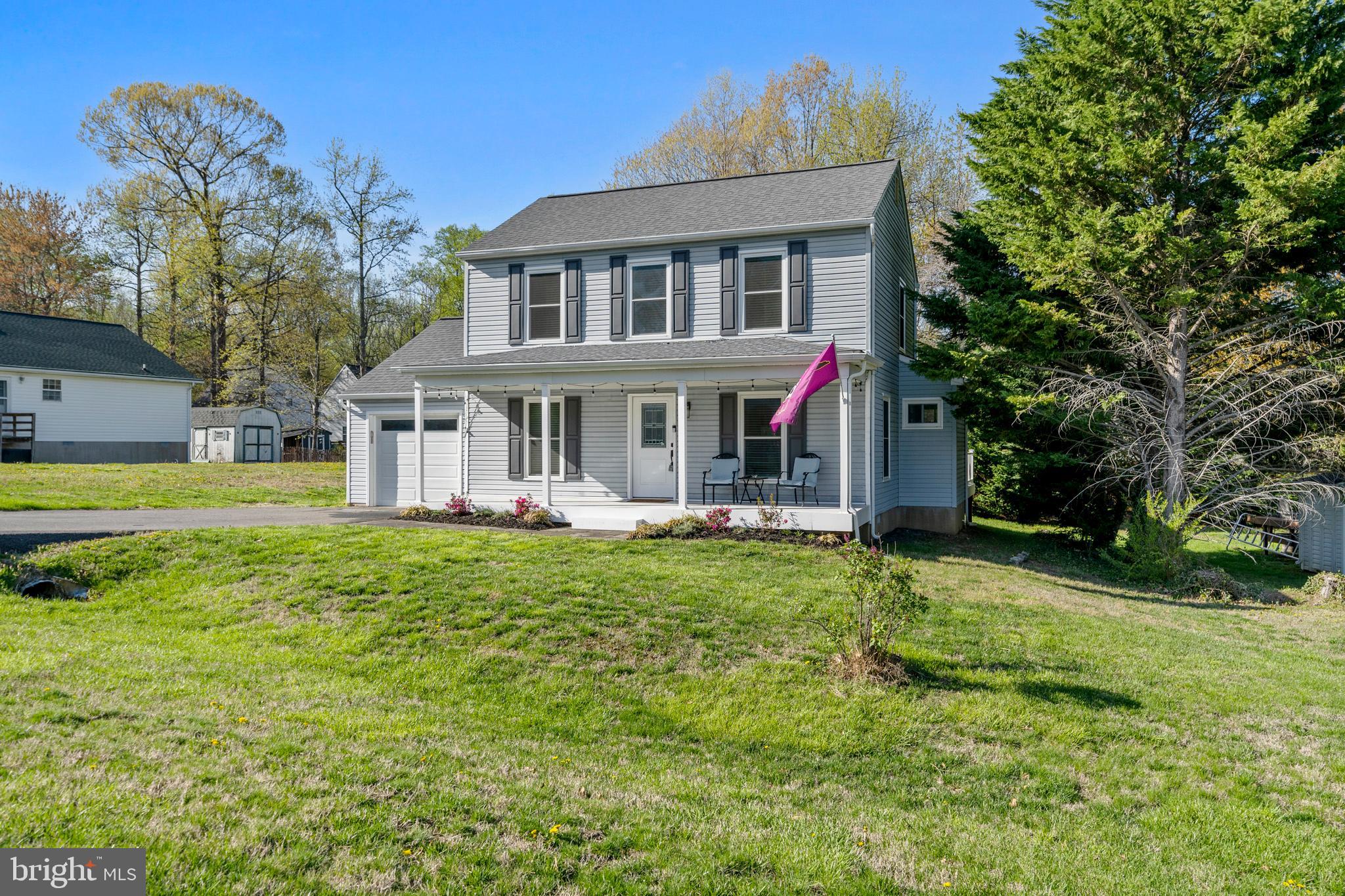 3704 9th Street North Beach, MD 20714 - Photo 29 of 42 a front view of a house with a garden