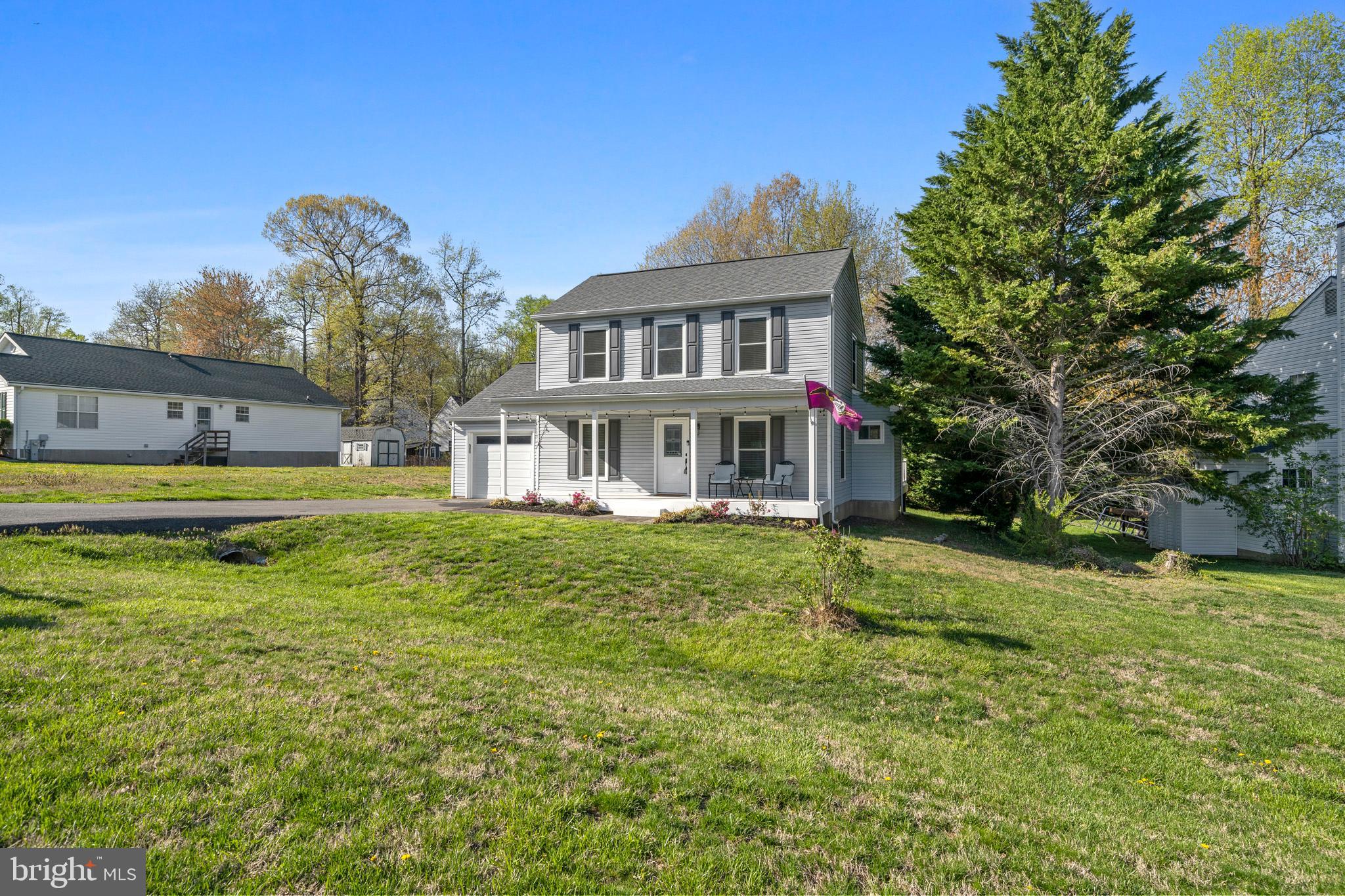 3704 9th Street North Beach, MD 20714 - Photo 30 of 42 a front view of a house with a yard table and chairs