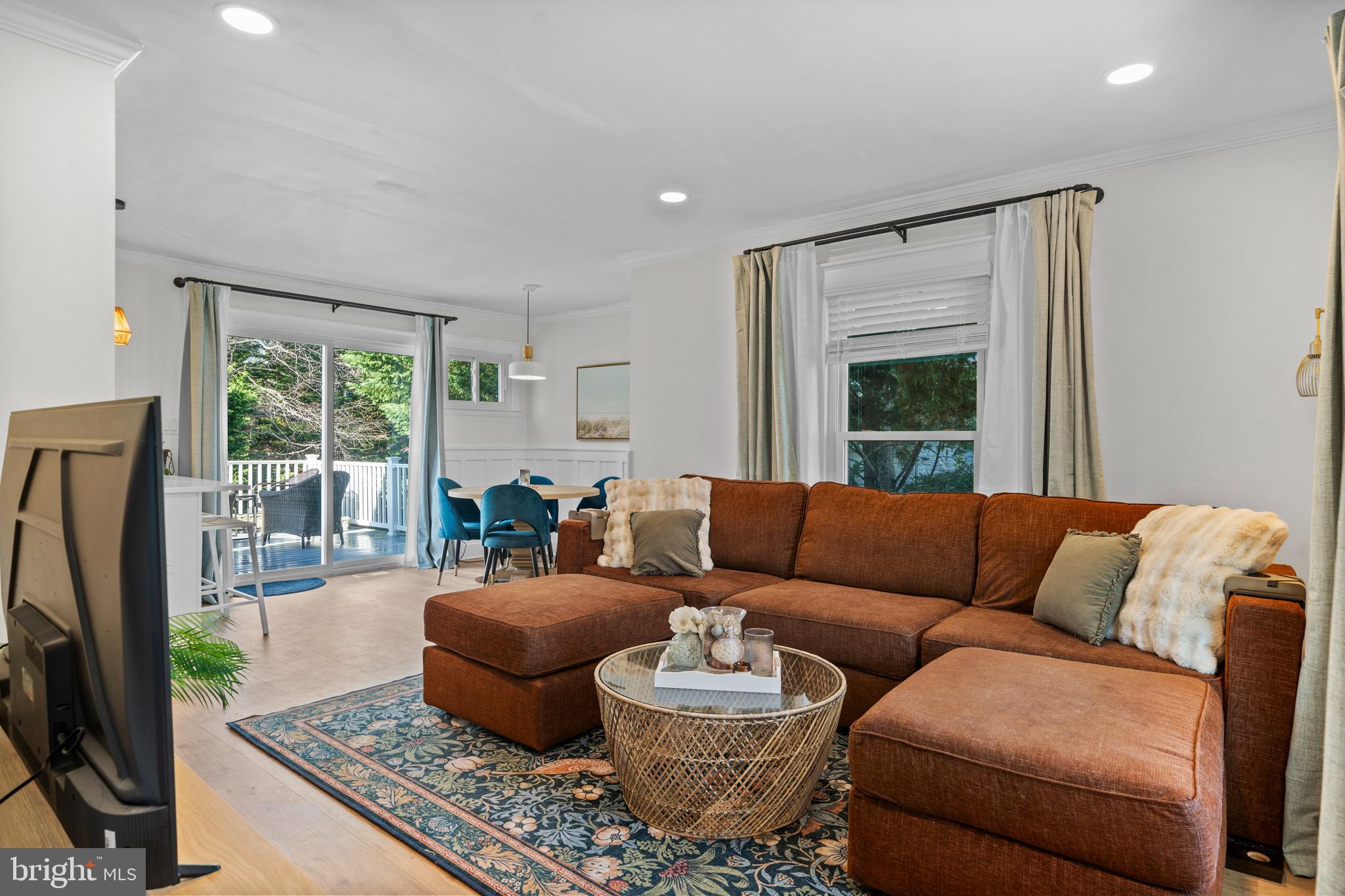 3704 9th Street North Beach, MD 20714 - Photo 42 of 42 a living room with furniture and a flat screen tv