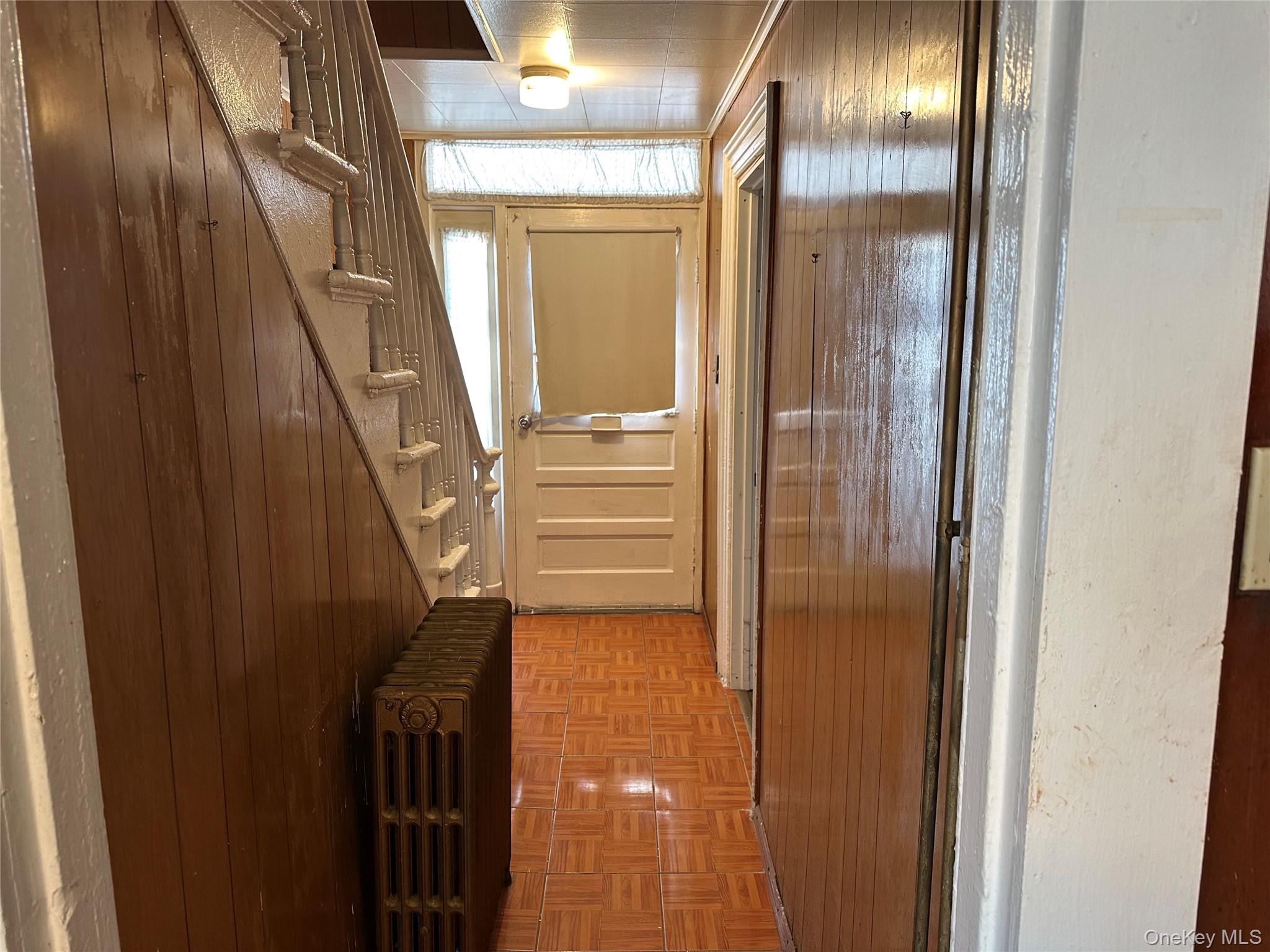 76 Church Street Beacon, NY 12508 - Photo 12 of 26 Hallway featuring radiator heating unit and stairway