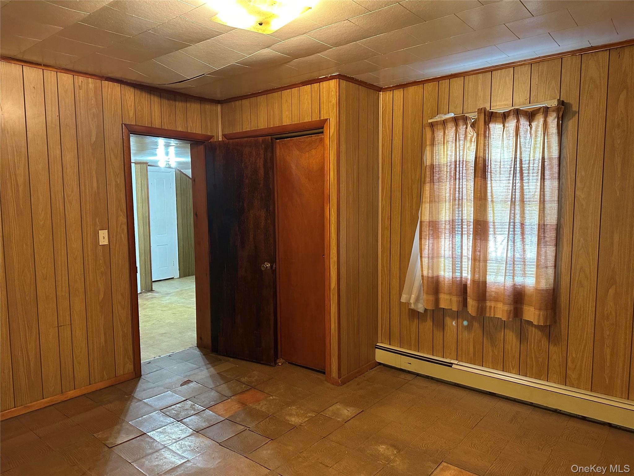 76 Church Street Beacon, NY 12508 - Photo 15 of 26 2nd bedroom railroad-style featuring wooden walls and a baseboard radiator