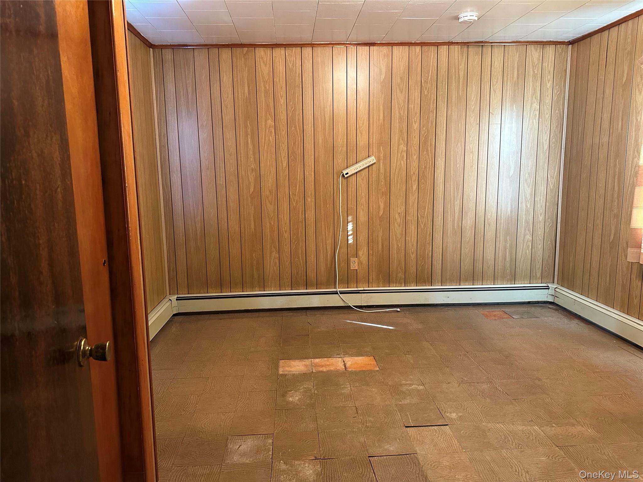 76 Church Street Beacon, NY 12508 - Photo 16 of 26 Empty room featuring dark flooring and wooden walls