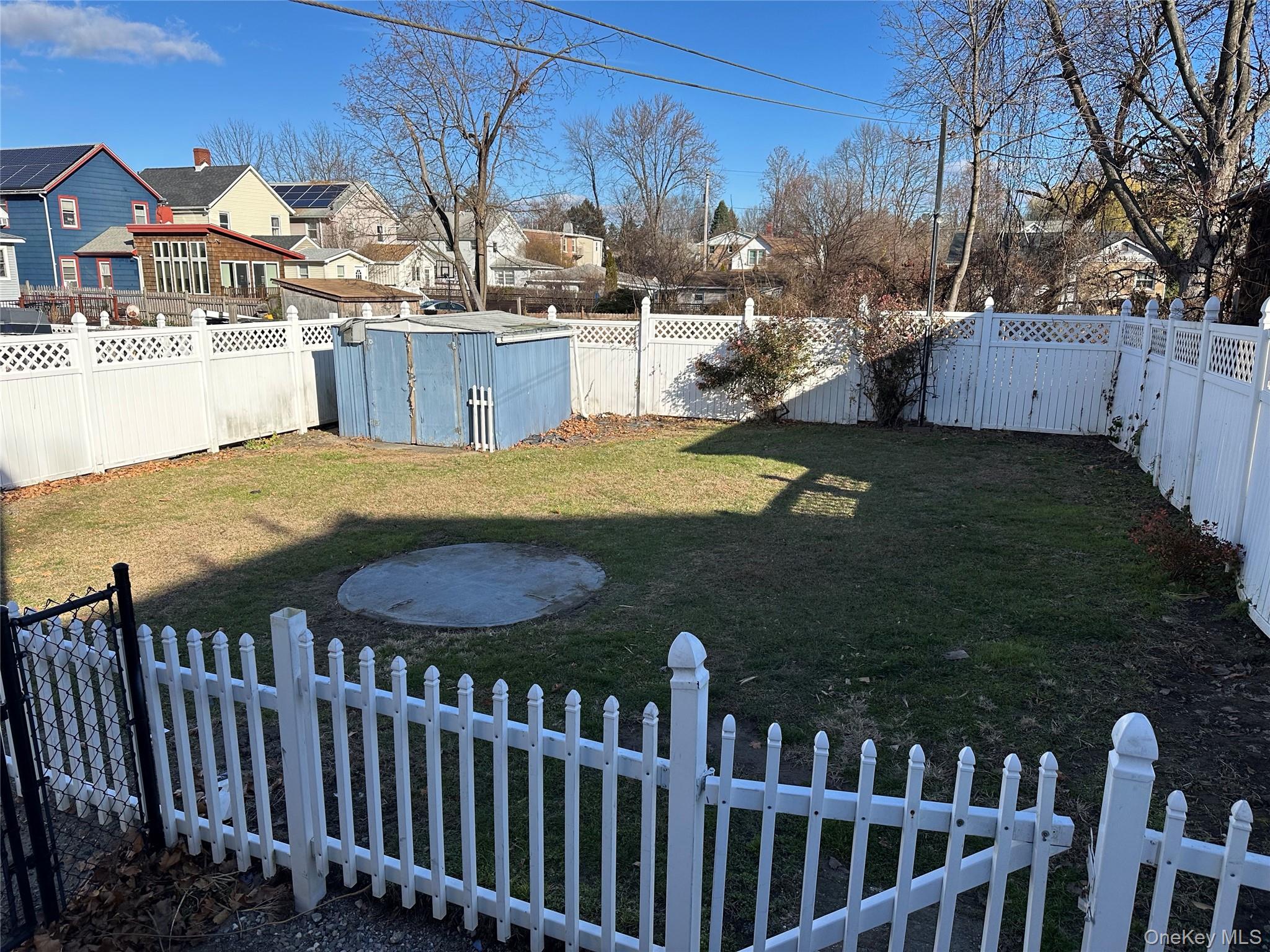 76 Church Street Beacon, NY 12508 - Photo 25 of 26 Fenced backyard with a residential view and a shed