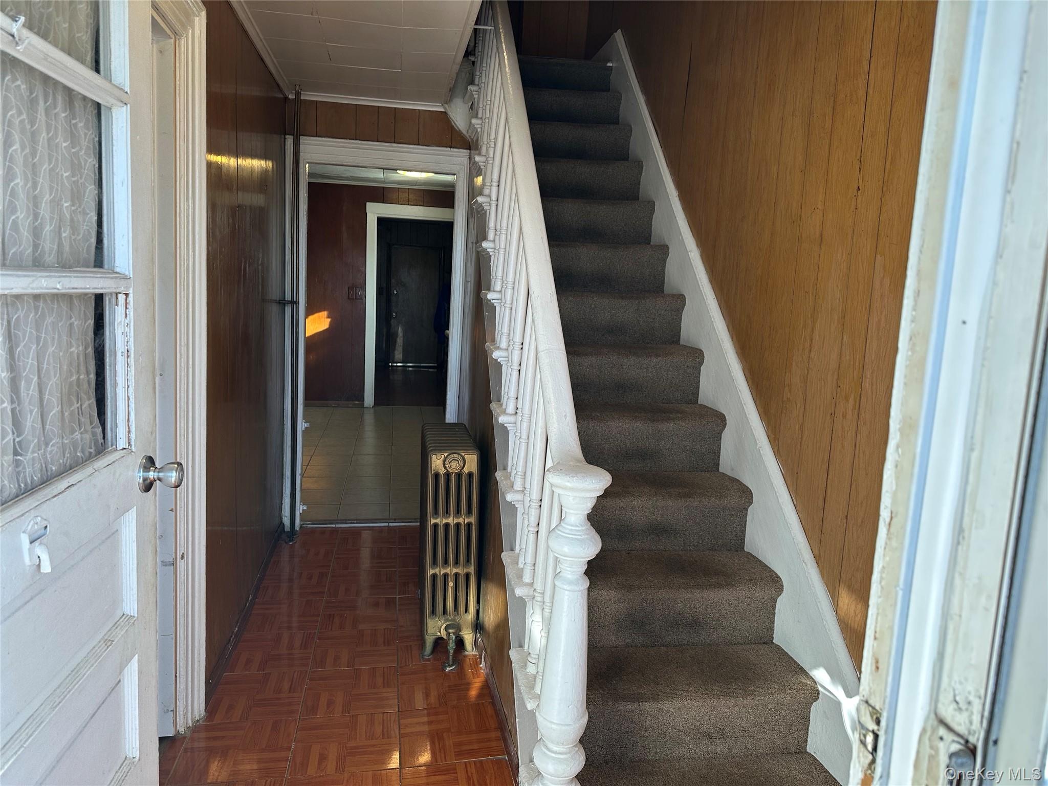 76 Church Street Beacon, NY 12508 - Photo 3 of 26 Stairs featuring wood walls and radiator