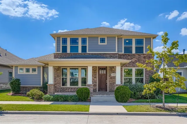 a view of a brick house with a yard next to a yard