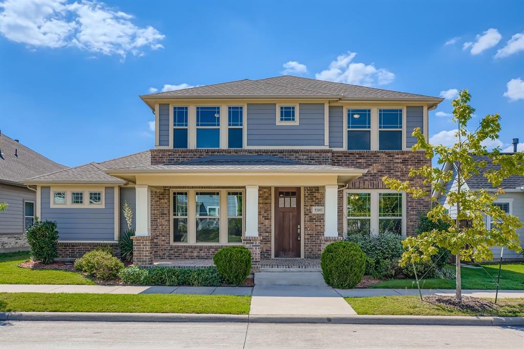 a view of a brick house with a yard next to a yard