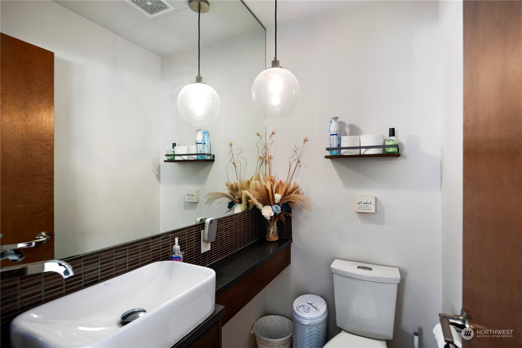 218 North 39th Street Seattle, WA 98103 - Photo 14 of 27 a bathroom with a sink a toilet and mirror