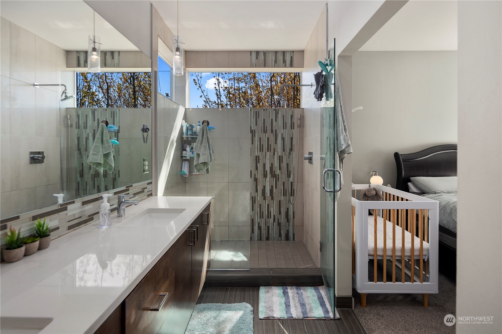 218 North 39th Street Seattle, WA 98103 - Photo 23 of 27 a en suite bathroom with a sink a mirror and shower
