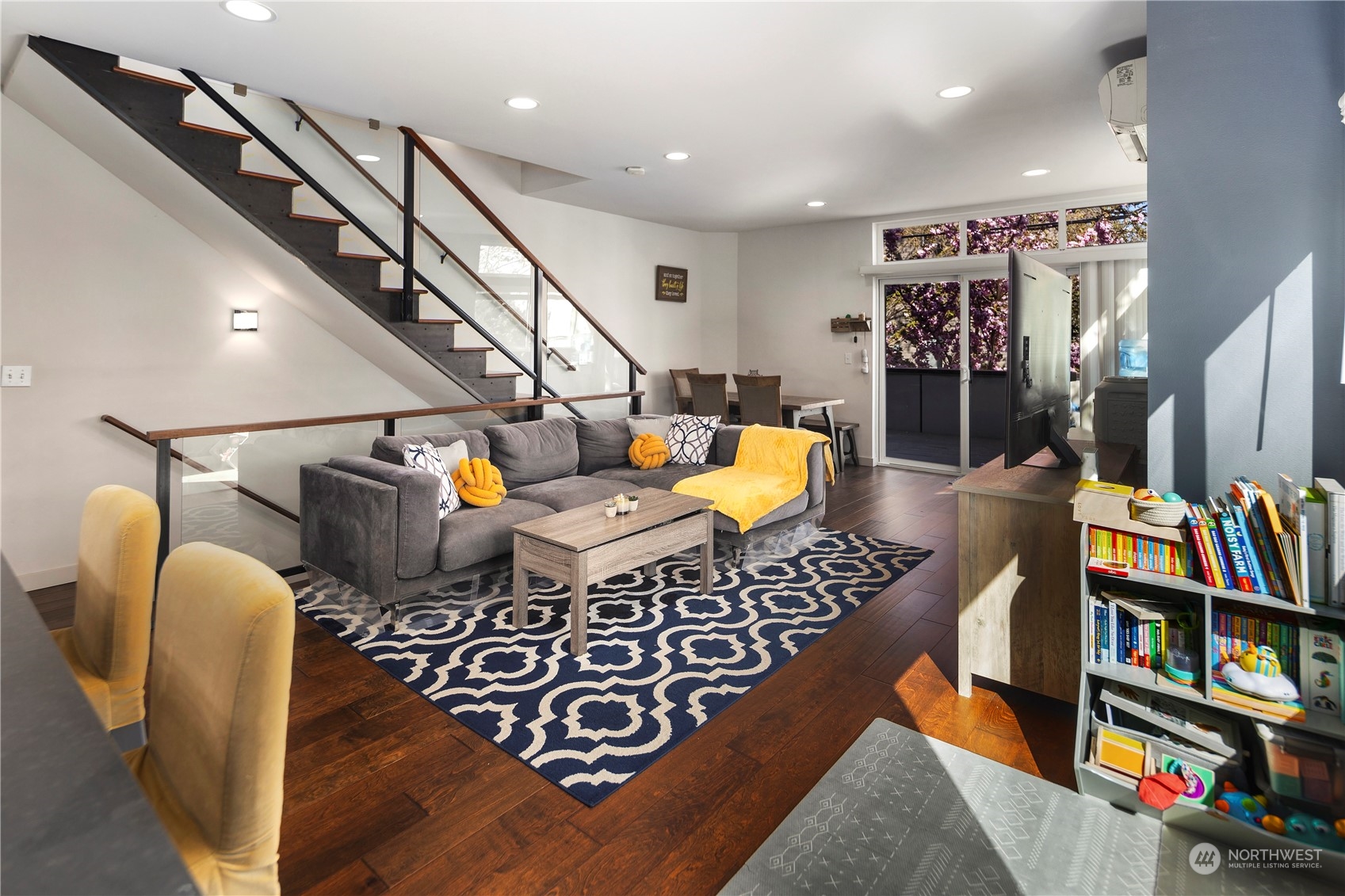 218 North 39th Street Seattle, WA 98103 - Photo 8 of 27 a living room with furniture a rug and a book shelf