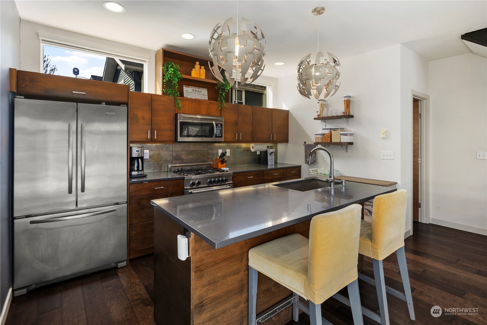 218 North 39th Street Seattle, WA 98103 - Photo 9 of 27 a kitchen with stainless steel appliances granite countertop a sink refrigerator and microwave