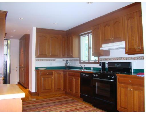 28 Byfield Road Newton, MA 02468 - Photo 4 of 8 a kitchen with stainless steel appliances granite countertop a stove a sink and a microwave