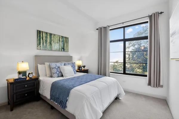 a spacious bedroom with a bed and a window