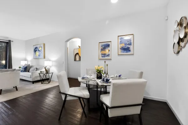 a living room with couches and a potted plant on table