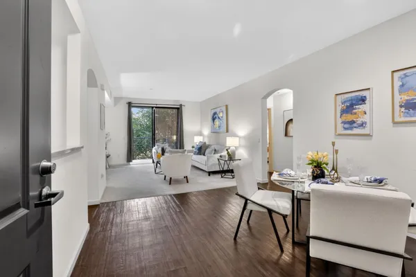 a living room with furniture and a wooden floor