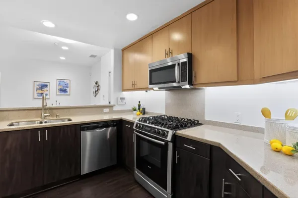 a kitchen with a sink a stove and cabinets