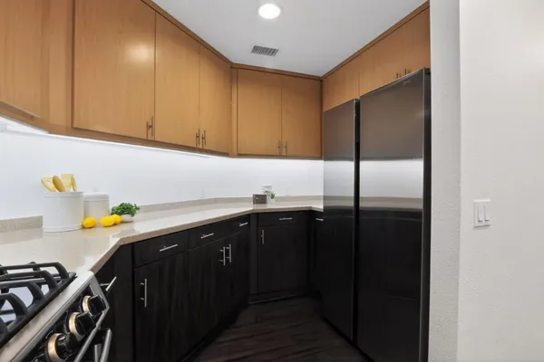 a kitchen with a sink a stove cabinets and utility
