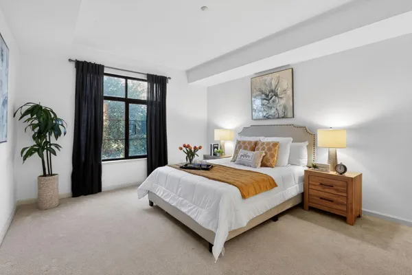 a spacious bedroom with a bed and a large window