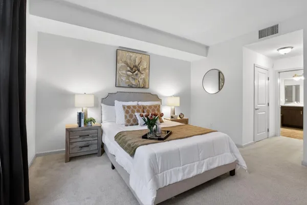 a bedroom with a bed and a lamp