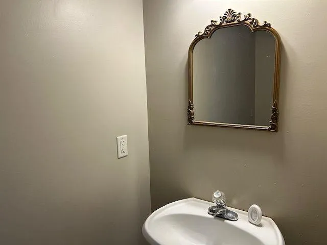 a bathroom with a sink and mirror