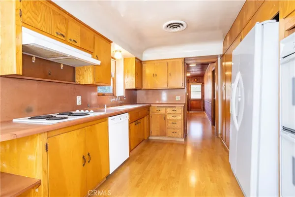 a kitchen with stainless steel appliances granite countertop a sink and a refrigerator