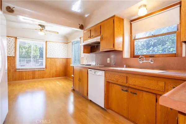 a kitchen with stainless steel appliances a sink a stove and a window