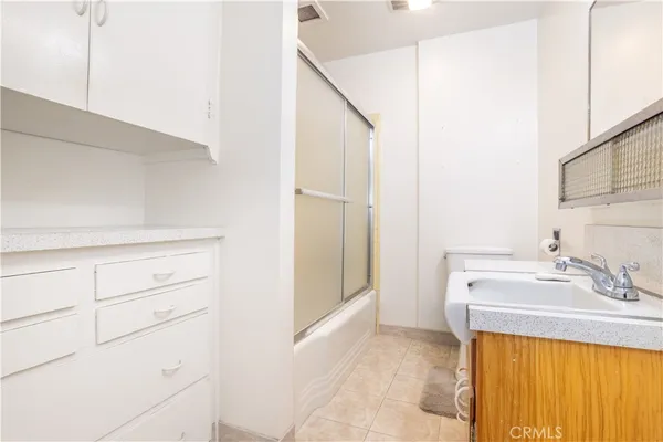 a bathroom with a sink and a washer dryer